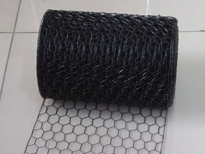 Black PVC coated hexagonal mesh in roll and part is unfold.