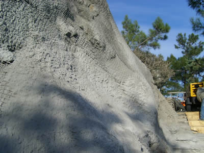 Concrete is used to applied onto the chain link wire mesh and slope surface.