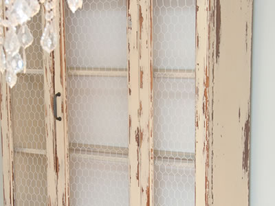 This picture shows that chicken wire is installed in cabinet.