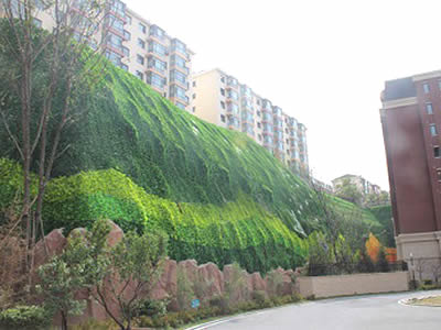 The picture shows a vegetated cliff with little decorations on it.