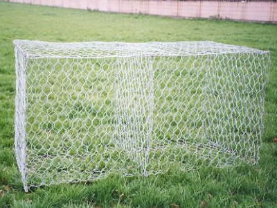 Two cells empty gabion basket is placed on grass land.
