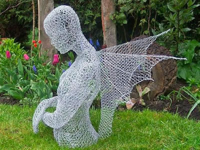 The picture shows a sculpture of upper body with wings made from galvanized hexagonal wire netting.