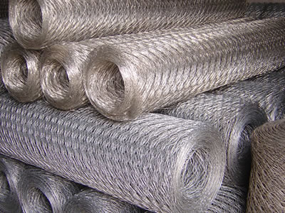 There are many galvanized hexagonal wire mesh rolls are placed neatly.
