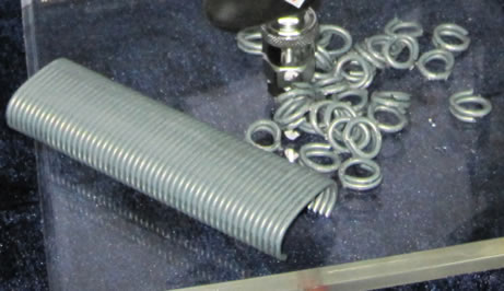There are many galvanized metal rings on the table.