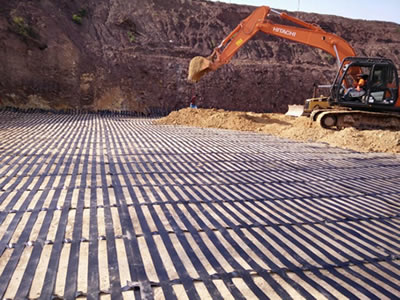 Geogrid is placed horizontally, soil is layered upon for a soil loss prevention effect.