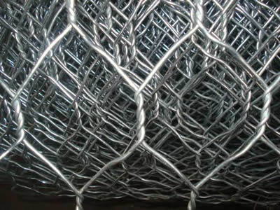 Two large mesh openings from a roll of hexagonal wire mesh are showed.