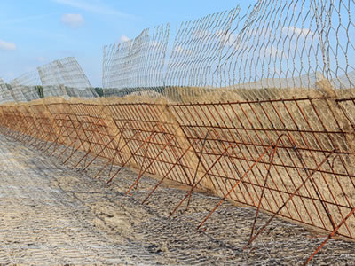 This picture shows an array of green terramesh which is standing on the ground, without proceeding soil filling.
