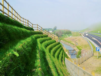 A road winds its way, a several level slope is located besides the way.