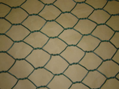 A piece of dark green normal double twist PVC coated hexagonal wire mesh.