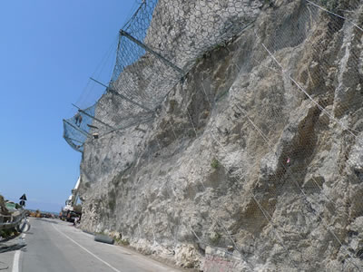 There are passive rockfall netting installed on half of mountain, and proactive rockfall netting installed below of passive rockfall netting.