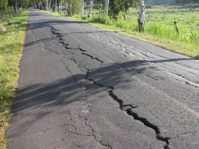 There is an asphalt road, full of reflective crackings, especially a huge one in the middle of the road.