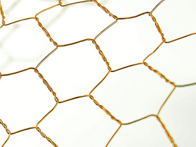 Golden reverse twist bronze hexagonal mesh with big holes.