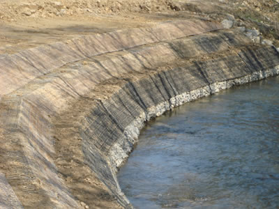 Green terramesh is used on the circum of a pond in a three level form.
