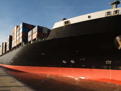 A black ship in harbor.