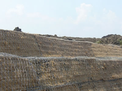 Trapezoidal gabion baskets are made into a two steps terrain slope.
